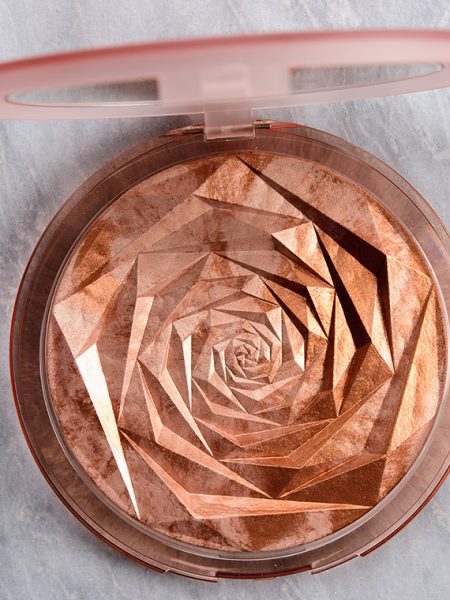 Huda Beauty Helios is a very warm-toned, medium copper with a metallic finish. It is a permanent highlighter